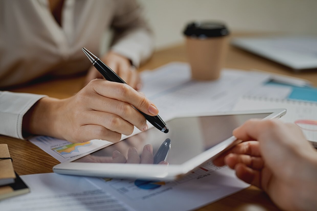 Woman Signing Contract on Digital Tablet